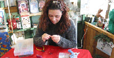 Angel Singh demonstrating the making of flower purses.